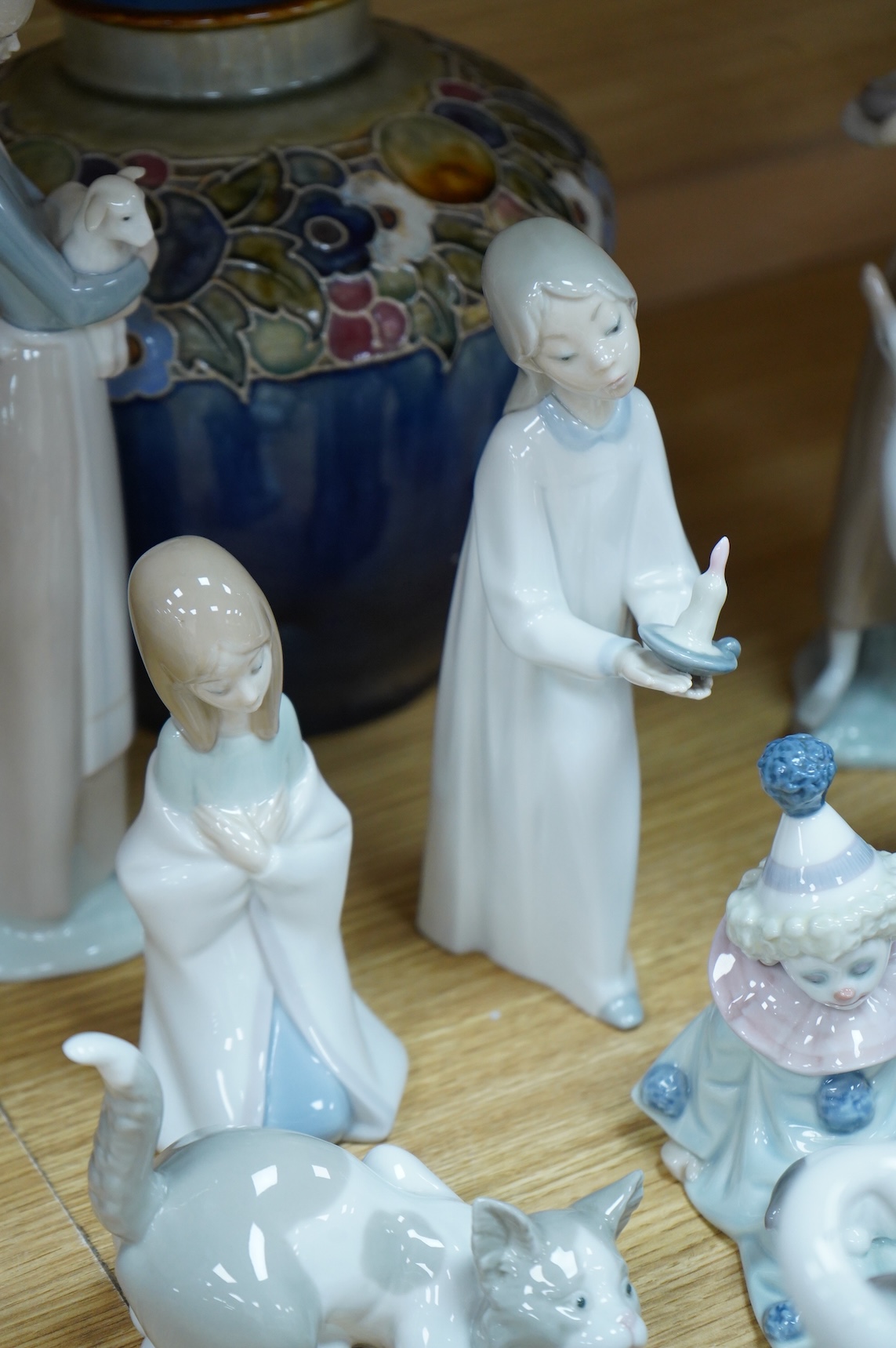 Two Doulton vases, a Casa Pupo pierrot dish and a collection of nine Lladro figures, largest 27cm high